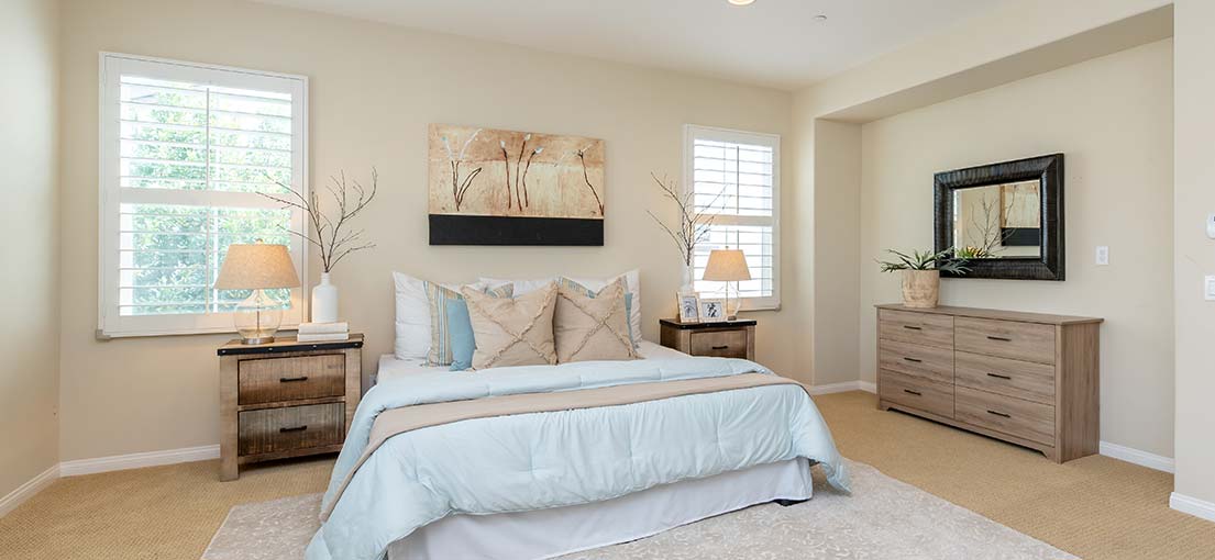 Stevenson Ranch bedroom with sleek white motorized blackout blinds for ultimate comfort.