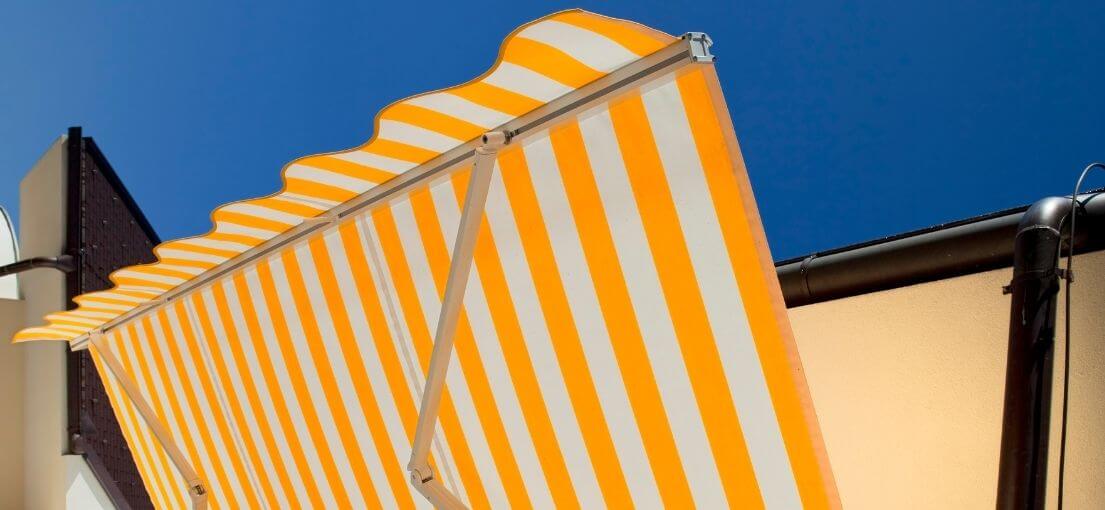 Detail of a motorized awning offering sun protection for a Lawndale deck.