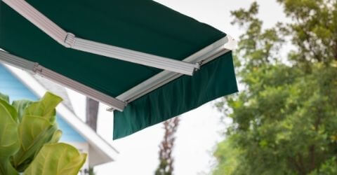 Patios with a shady green awning feature.