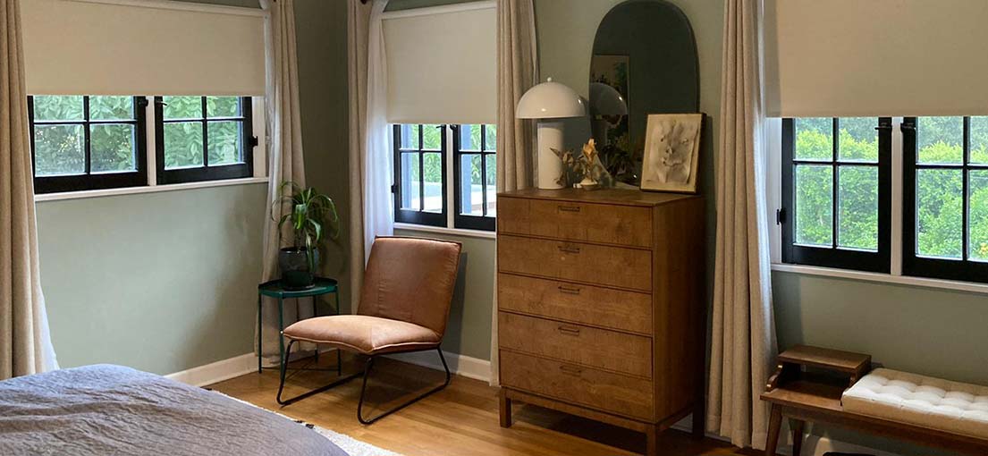 A view at motorized roller shades in bedroom