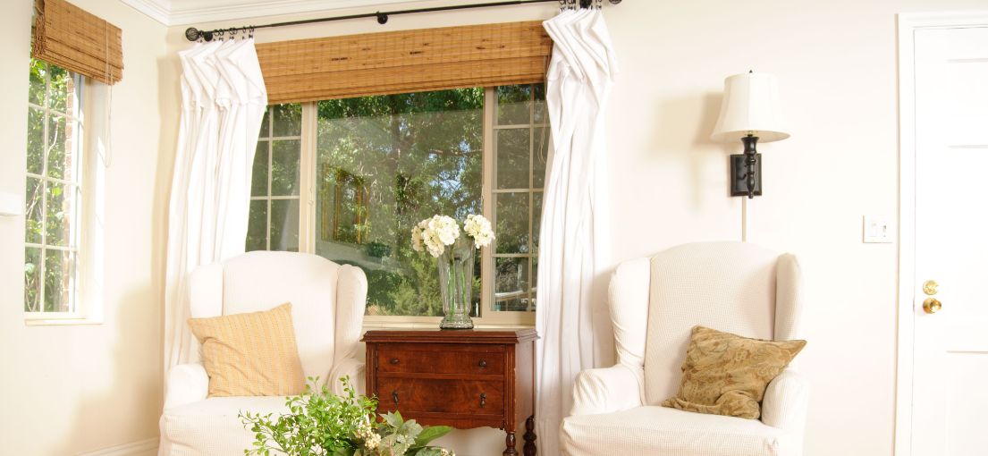 A view at a cozy bright living room with bamboo window shades