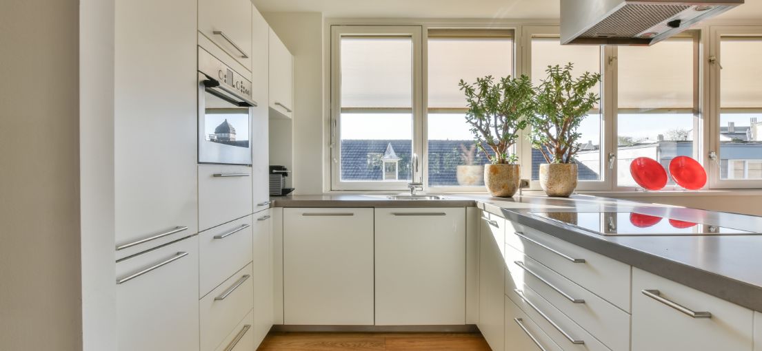 Bright and modern Culver City kitchen with custom roller shades by Master Blinds, enhancing aesthetics and functionality.