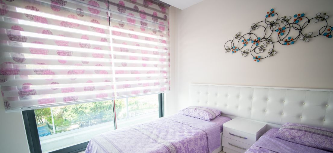 Bedroom with colorful layered window shades