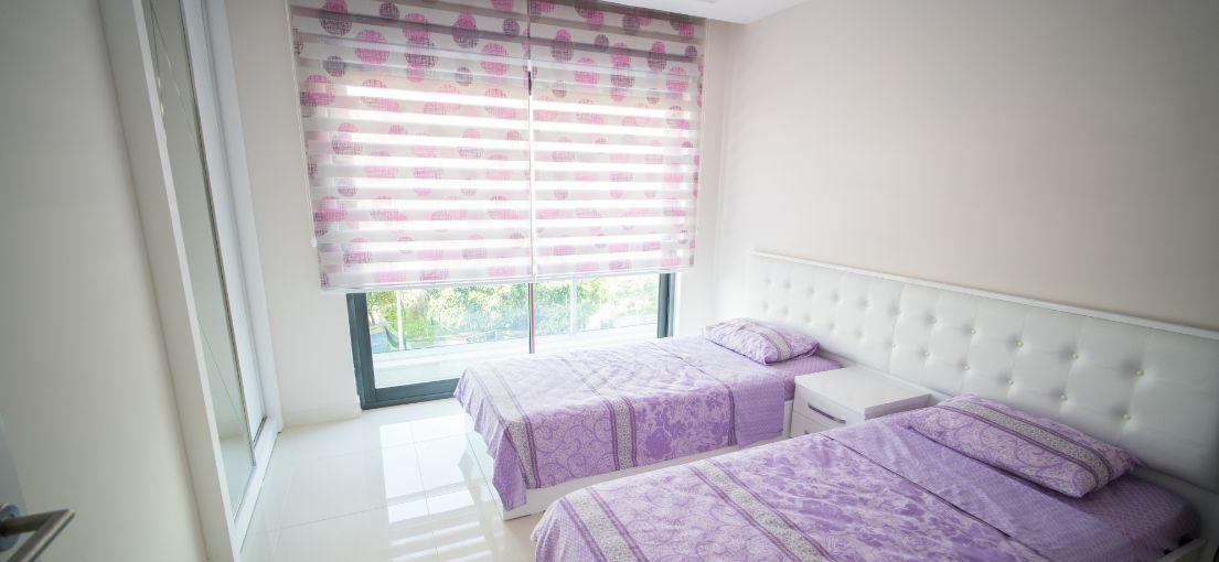 Bedroom with colorful layered window shades