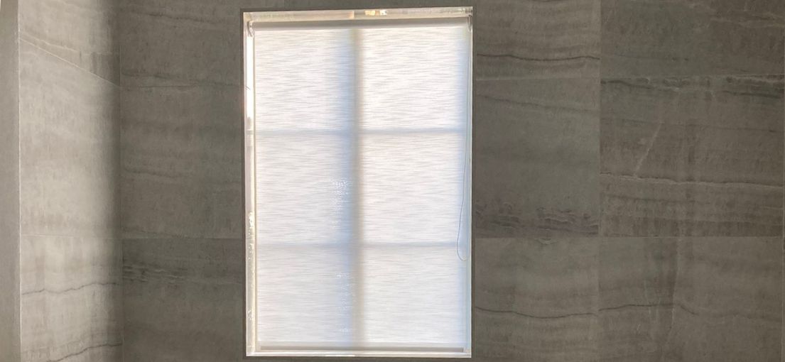 Sheer roller shade casting soft light in an upscale bathroom renovation in Encino.