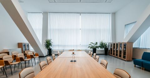 Spacious Malibu conference room featuring custom vertical blinds on a large window wall.