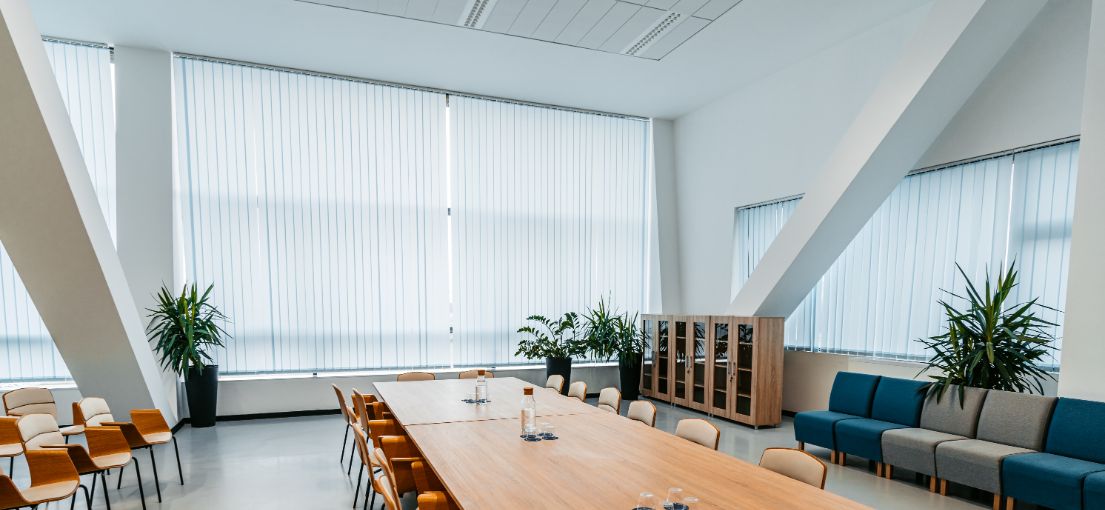 Interior view of a Malibu conference room with custom vertical window blinds providing light control.