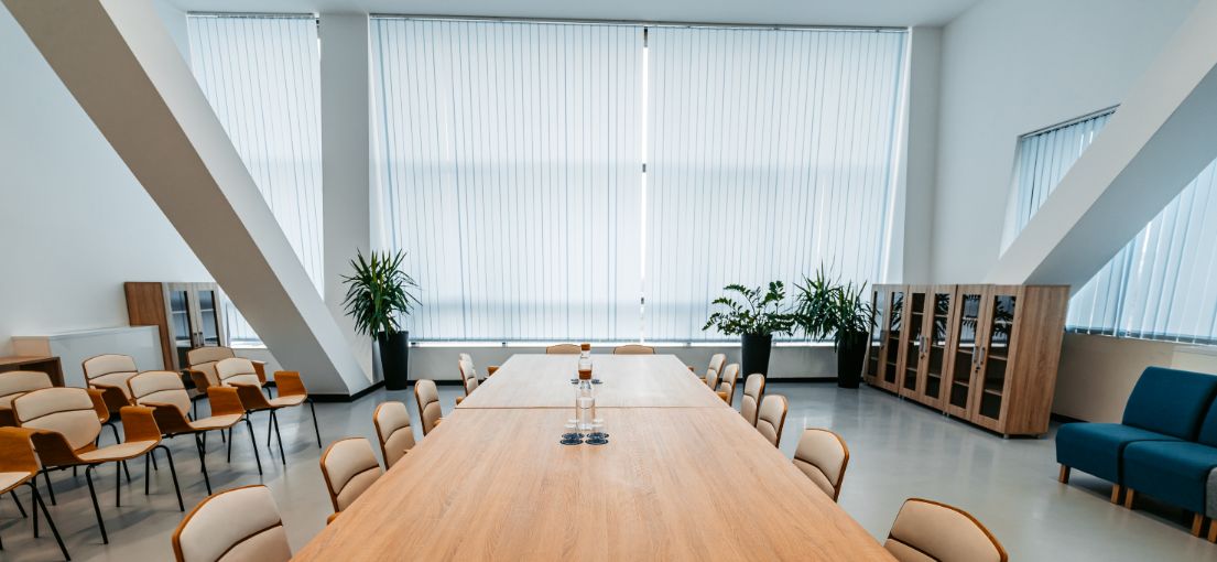 Stylish Malibu conference room showcasing custom vertical blinds on expansive windows.