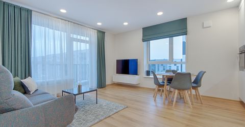 Modern condo in Marina Del Rey with Roman shades and custom curtains in the living room and kitchen.