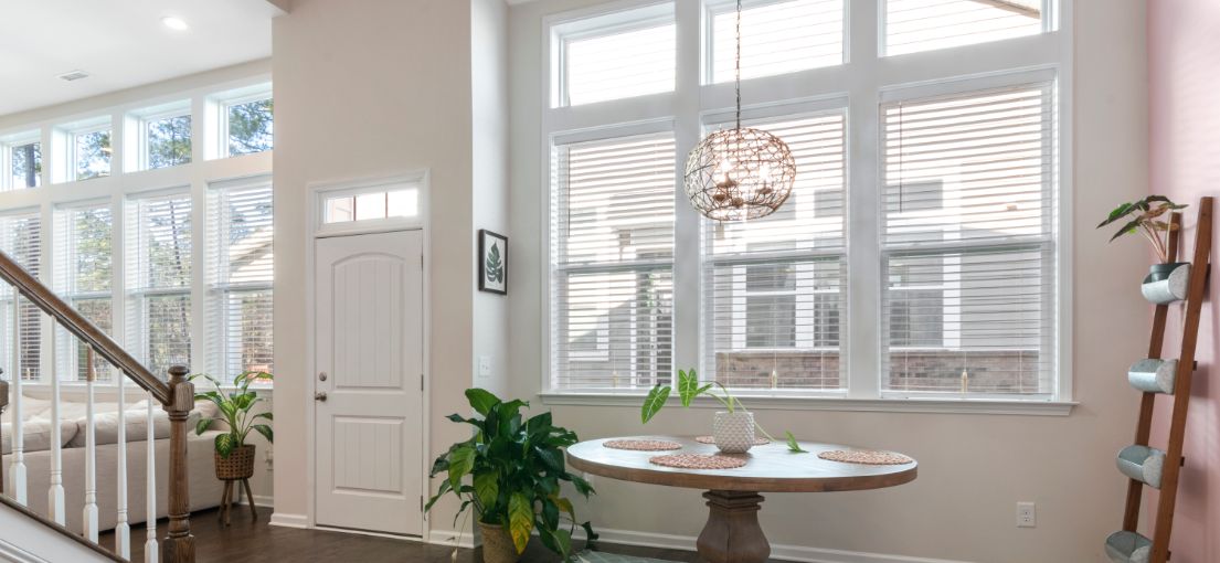 Stylish Northridge living room showcasing vinyl window blinds and vertical blinds for patio doors.