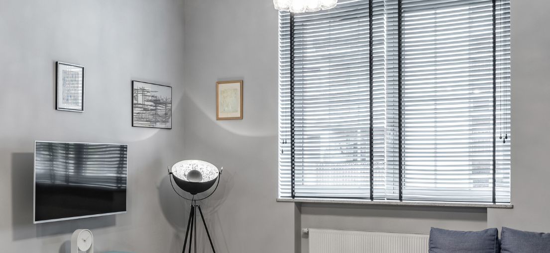 Modern living room in a studio with custom-fitted Venetian blinds.