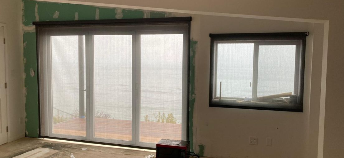 Remodeling process showing screen shades in a Westwood living room