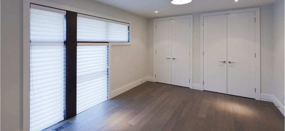 Newly installed room darkening vinyl blinds in a Burbank bedroom, enhancing privacy and style.