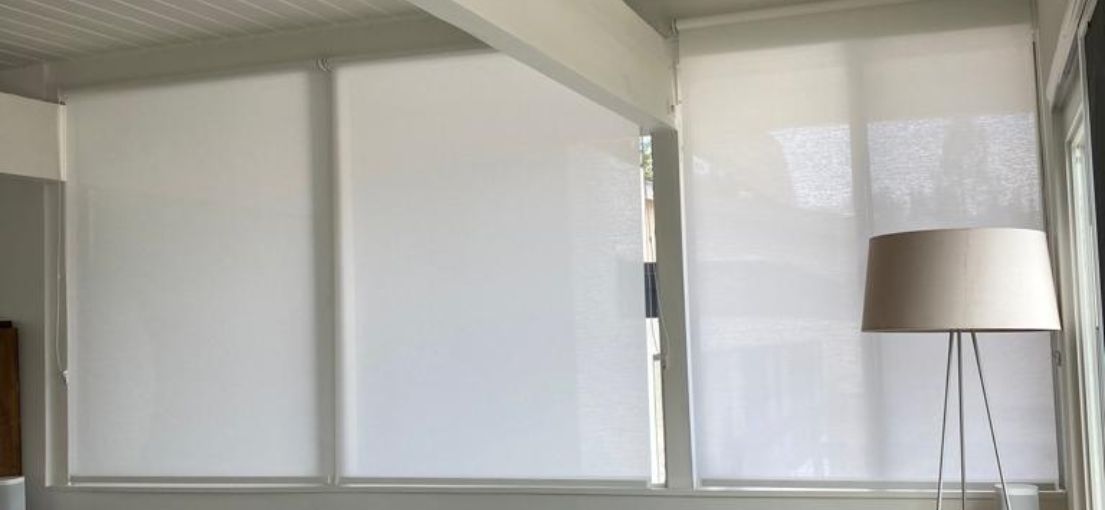 Masterful installation of bespoke roller blinds offering light control in a stylish urban dwelling.