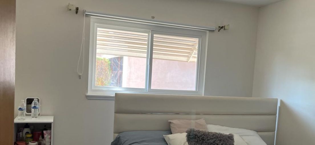 Pull down window shades installed in a Brentwood guest bedroom.