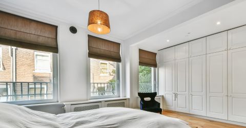 Culver City bedroom featuring elegant brown Roman shades offering a cozy retreat.