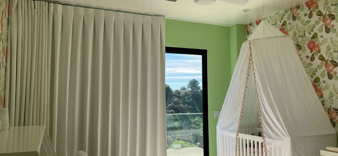 Custom blackout curtains providing a stylish and functional solution in a Hermosa Beach nursery room.