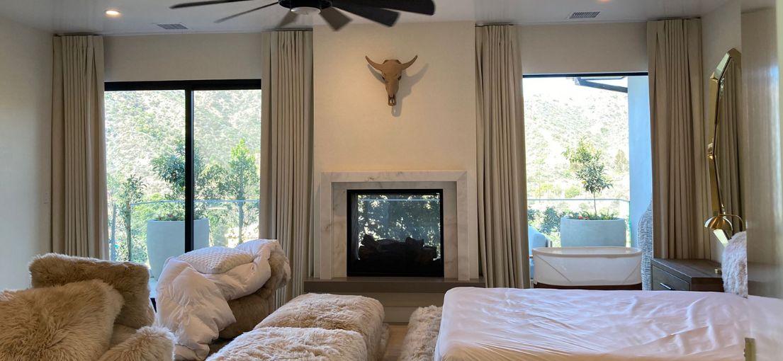 Blackout drapes framing large windows in a peaceful Hermosa Beach bedroom.