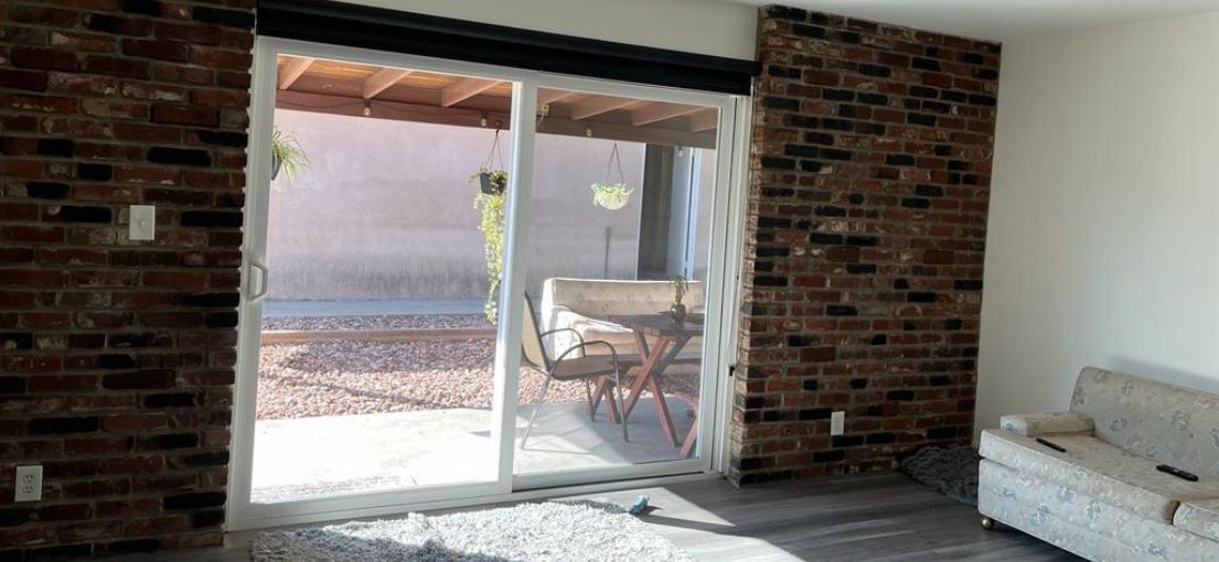 Modern screen roller shades on a Calabasas living room patio door, filtering natural light.