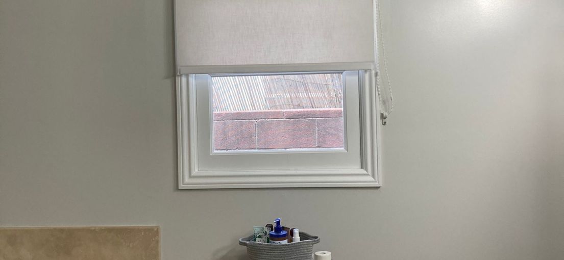 Sheer roller shades providing light control and privacy in an Agoura Hills bathroom.