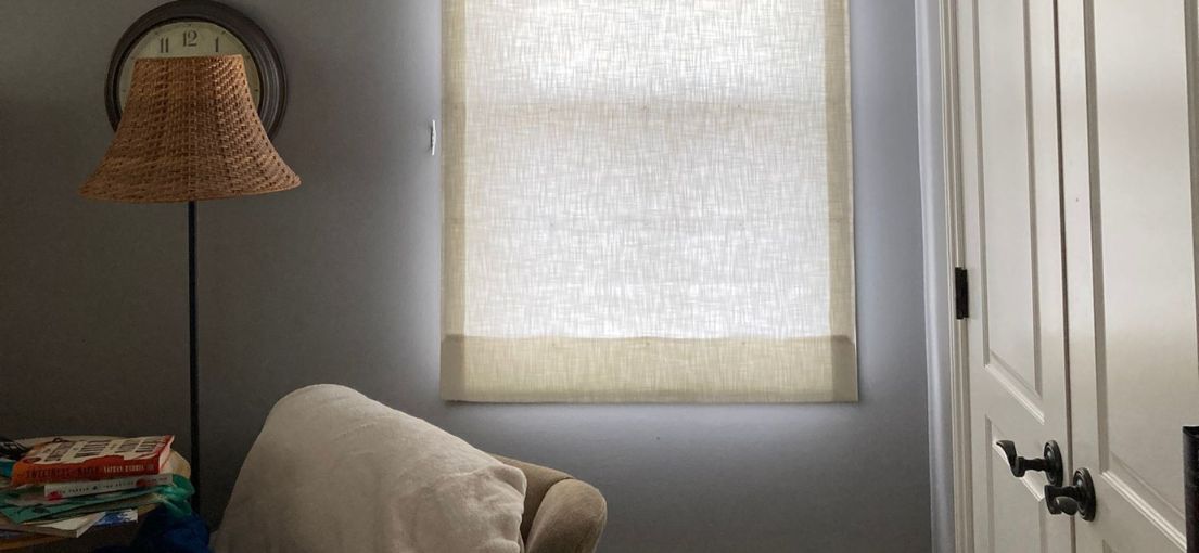 Elegant sheer roller shades in a neutral-tone bedroom window in Agoura Hills, enhancing the room’s ambiance.