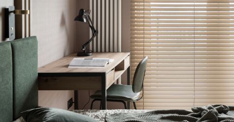 A modern Tarzana bedroom featuring sleek room darkening vinyl blinds on a large glass wall, showcasing a stylish and functional design.