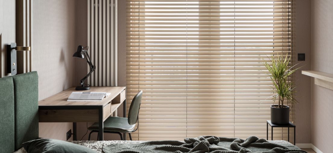 A spacious bedroom in Tarzana featuring room darkening vinyl blinds, providing a perfect blend of style and functionality against a modern backdrop.