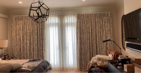 Elegant bedroom in Venice with light curtains and floral drapes.