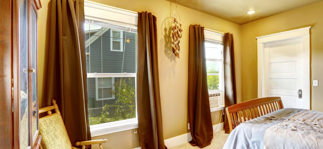 Custom-made blackout drapes covering bedroom windows in Malibu, ensuring privacy and style.