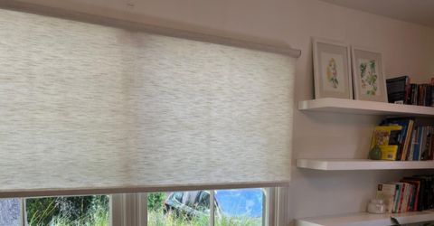 Sheer roller shades partially pulled down in cozy Sunland living room.