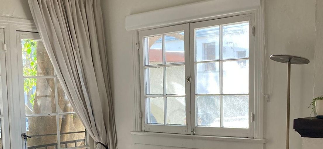 Bright laundry room in Chatsworth with sheer white shades fully opened, letting in natural light.