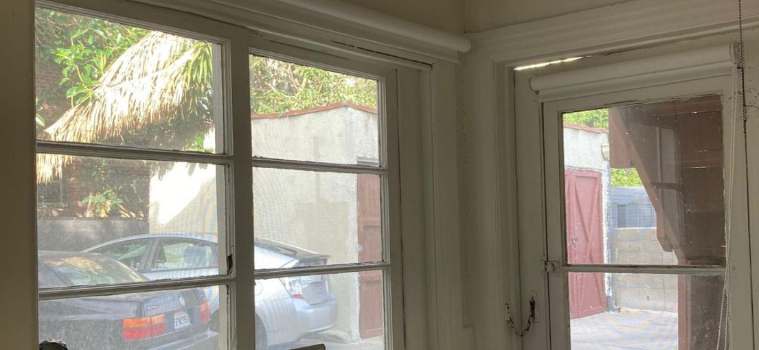 Bright laundry room in Chatsworth with sheer white shades fully opened, letting in natural light.