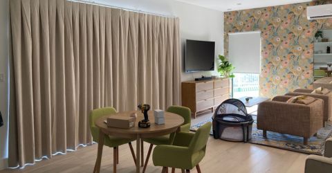 Modern living and dining room in Thousand Oaks featuring custom drapes by Master Blinds for light control.