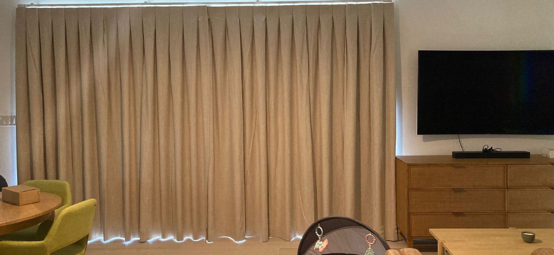 Stylish living and dining room in Thousand Oaks with custom blackout drapes installed by Master Blinds.