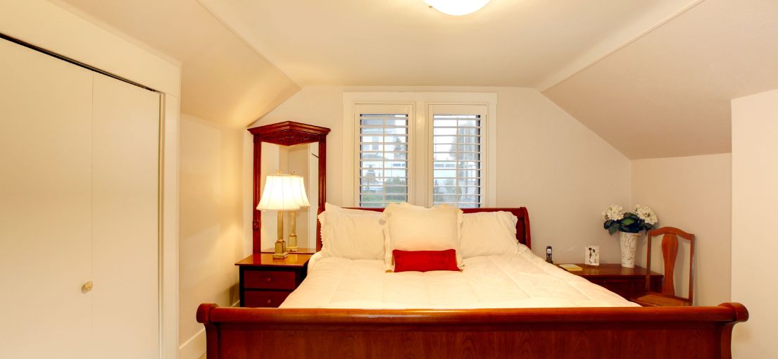 Santa Monica bedroom featuring custom plantation shutters for adjustable light control and enhanced privacy.