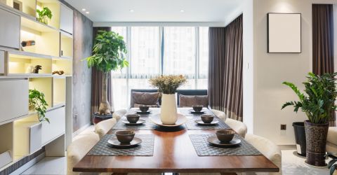 Modern dining room featuring layered window treatments with illuminated display wall