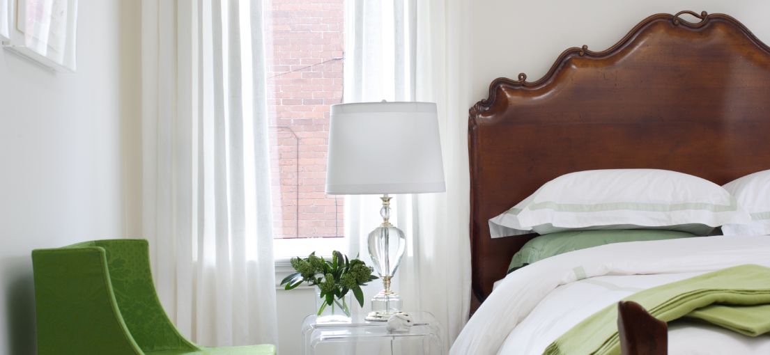 Classic bedroom with custom curtains and gold-accented decor in Santa Monica.