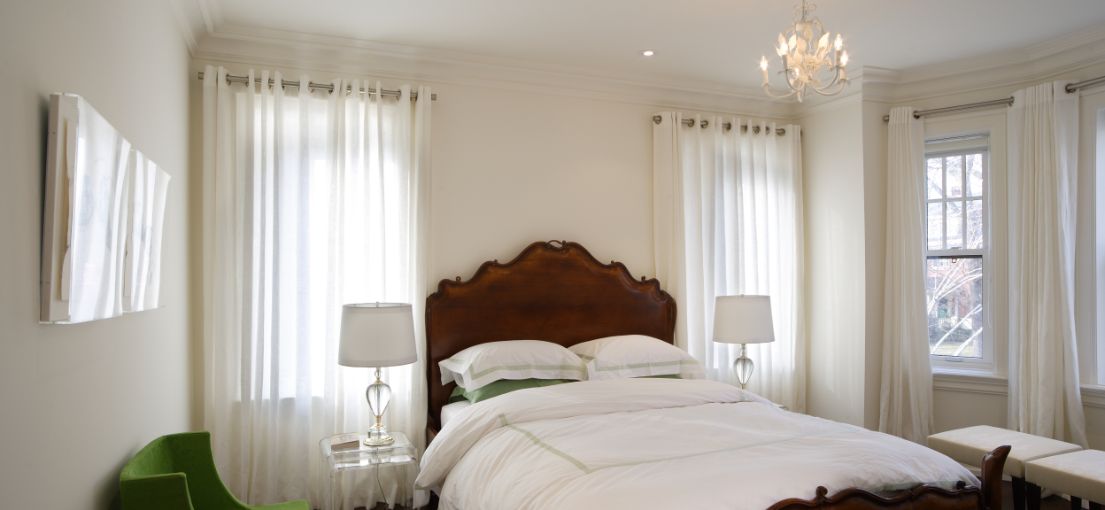 Luxurious white custom curtains installed in a Santa Monica bedroom by Master Blinds.