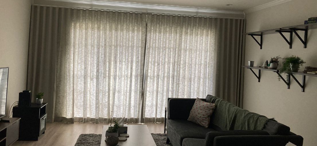 Stylish custom curtains in a Sherman Oaks home by Master Blinds, enhancing the natural light and creating a cozy, inviting space.